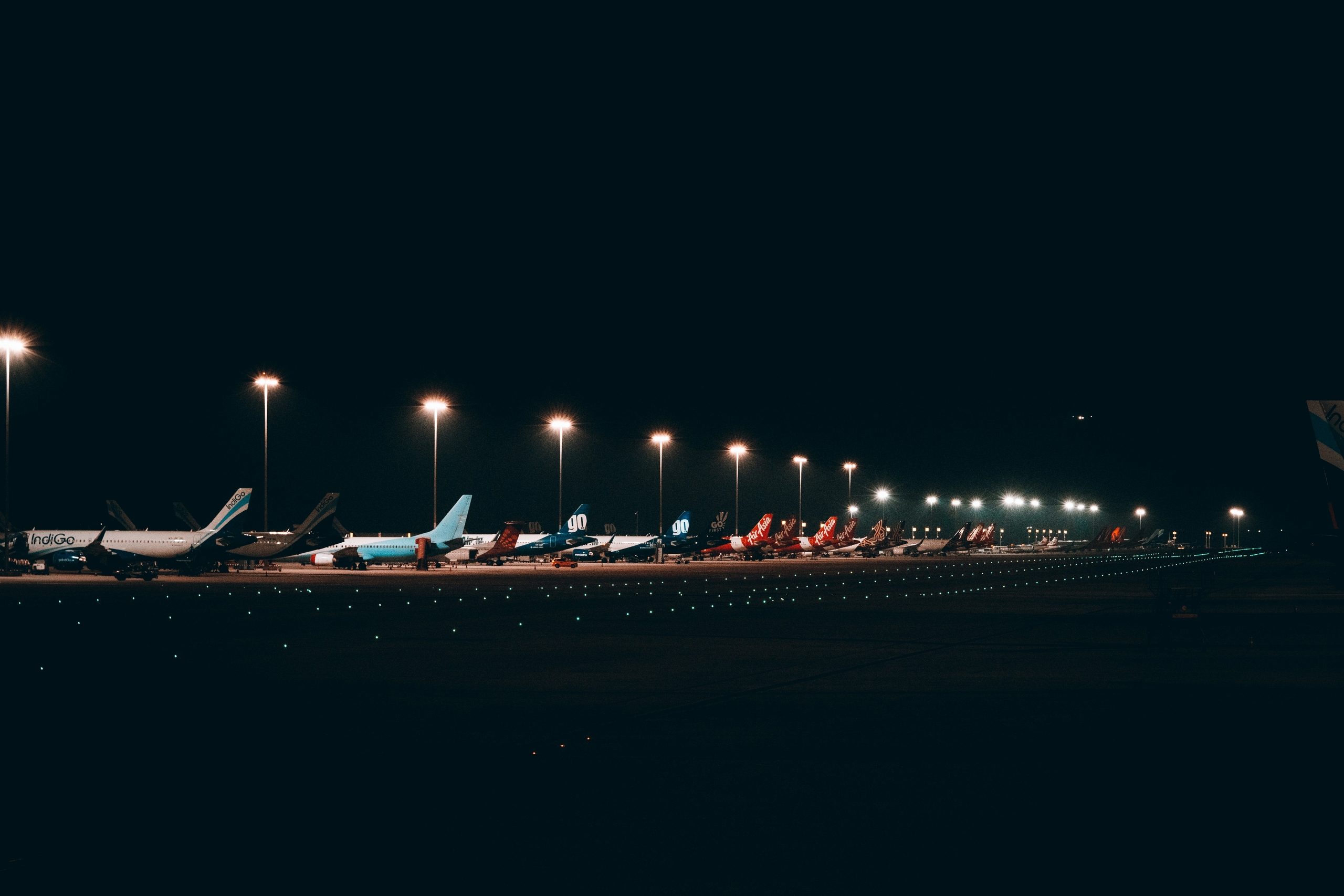 Passenger aircraft parked at an airport gate at night