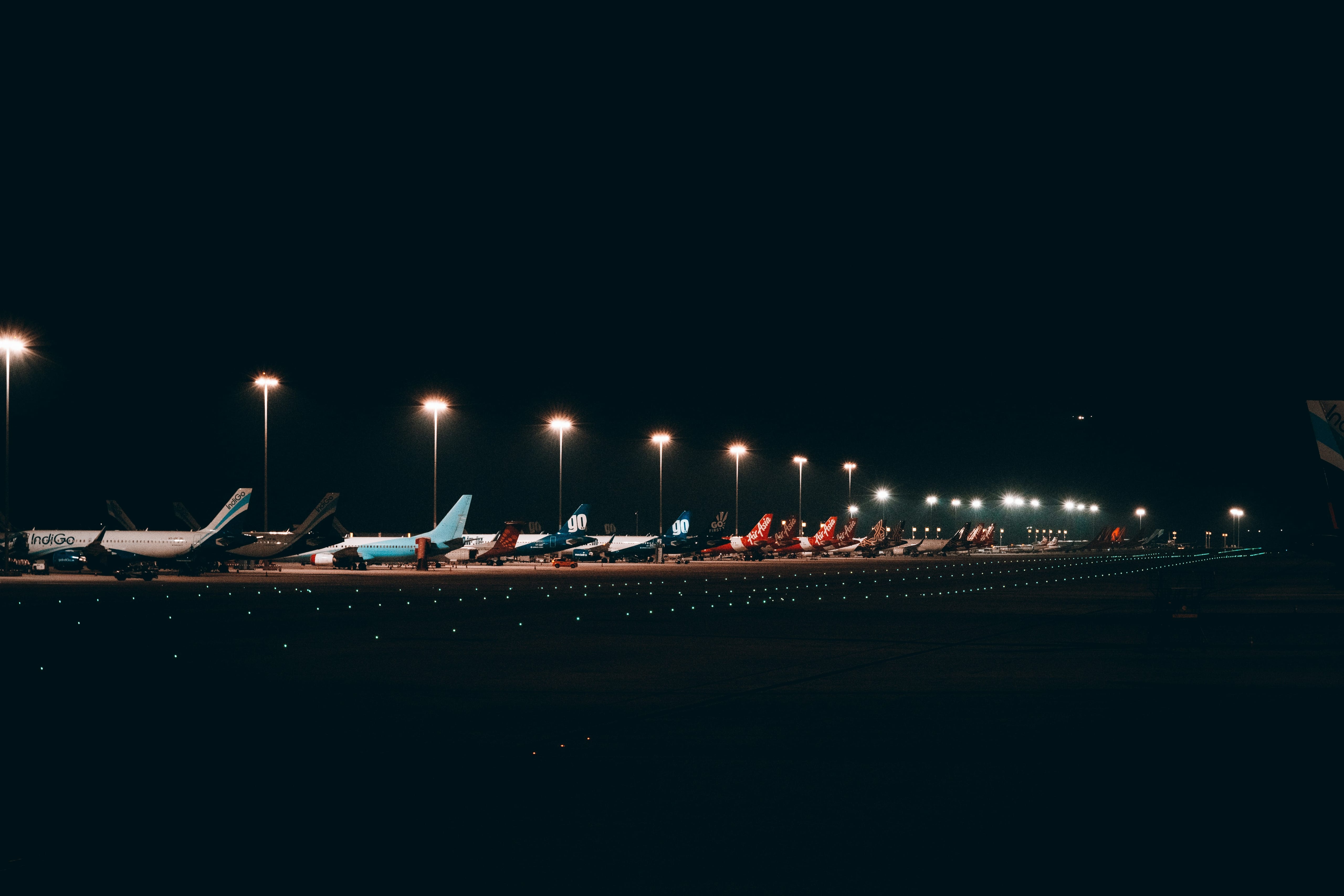 Passenger aircraft parked at an airport gate at night